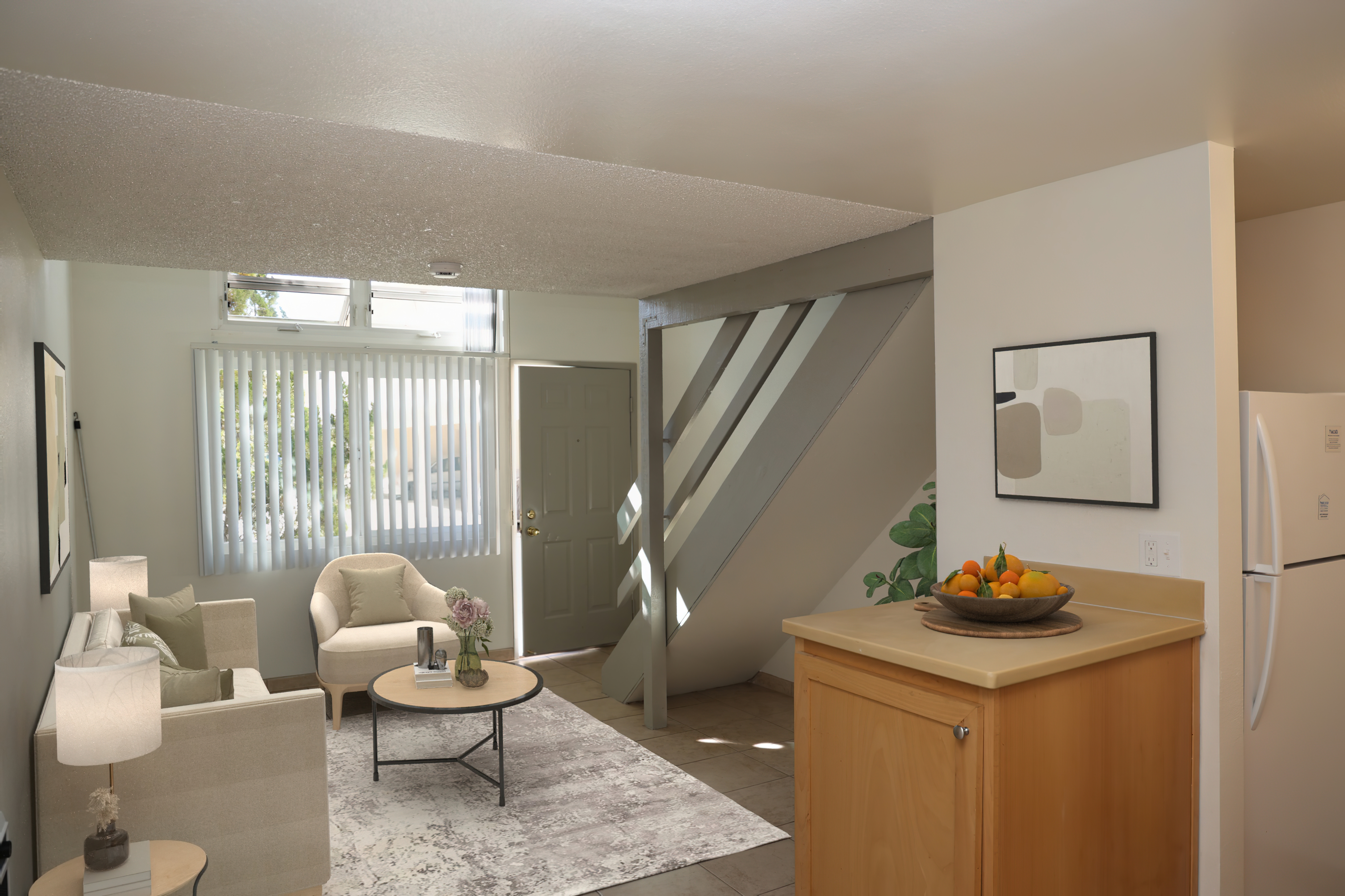Living room with natural light from a large window near the entry
