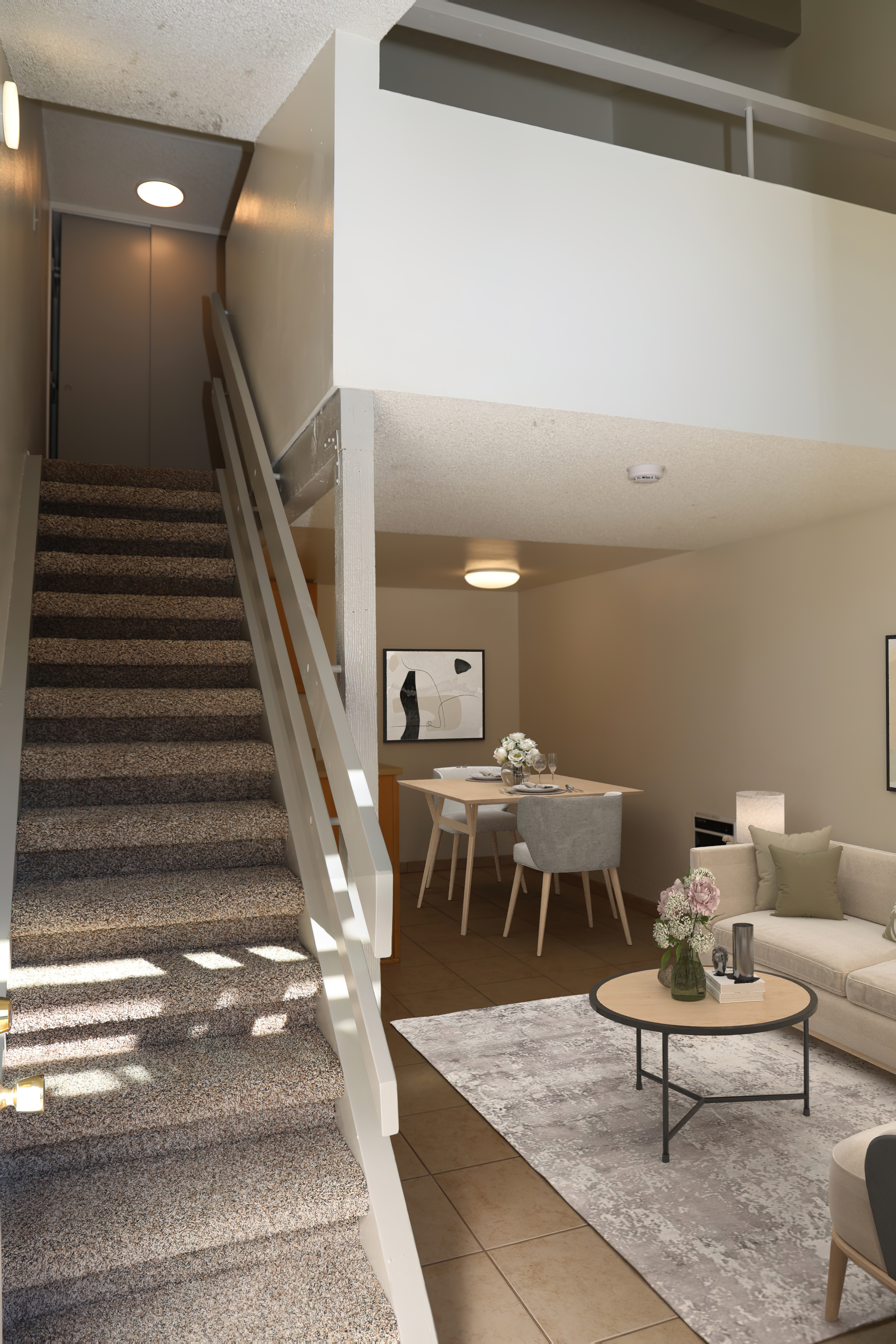 Two-story loft apartment with a carpeted staircase and high ceilings